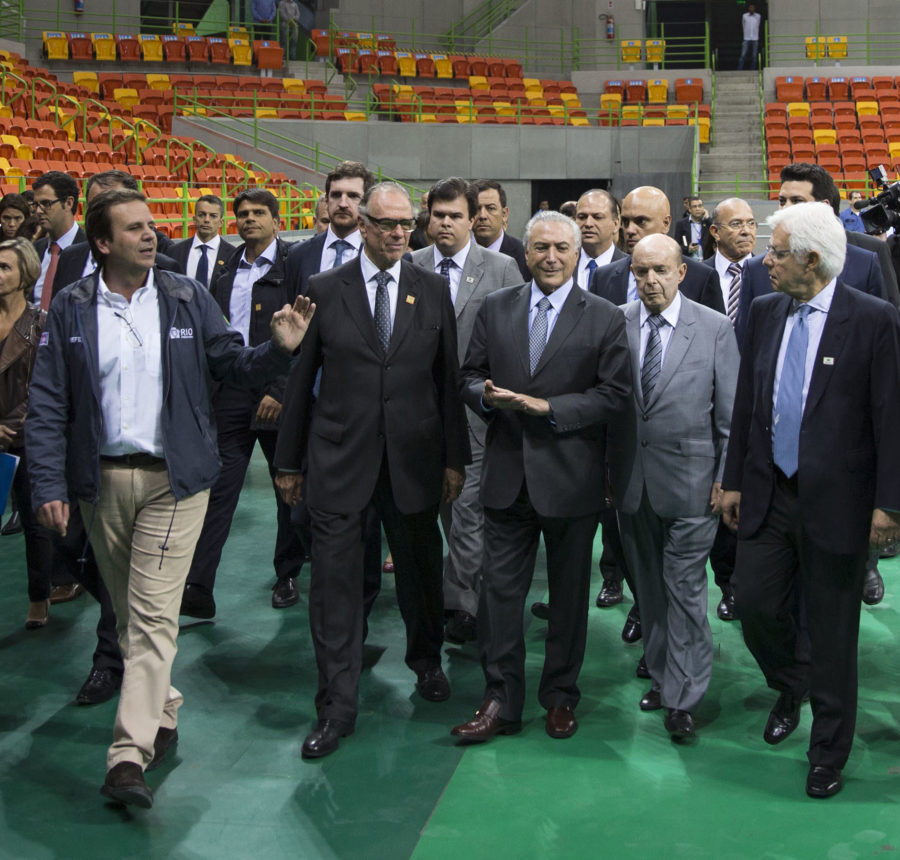 Brazils interim President Michel Temer, center, walks with officials during a visit to the Olympic Park in Rio de Janeiro, Brazil, Tuesday, June 14, 2016. In recent weeks Temer has stepped up his pledges of support for the Olympic games, which have been beset by a series of problems including the ongoing political crisis, Brazils worst recession in decades and an outbreak of the Zika virus, which has been linked to birth defects in infants. Just to the right of Temer is Rios interim governor Francisco Dornelles, and just left of Temer is Brazil Olympic Committee President Carlos Arthur Nuzman. (AP Photo/Felipe Dana)