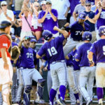 Teammates celebrate withTCU's Luken Baker (19) at the dugout after he hit a three-run home run against Texas Tech during the ninth inning of an NCAA men's College World Series baseball game in Omaha, Neb., Sunday, June 19, 2016. TCU won 5-3. (AP Photo/Nati Harnik)