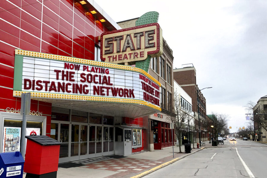 A movie theater marquee displays the message The Social Distancing Network.