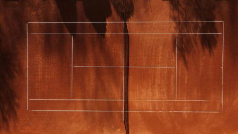 An empty tennis court shot from overhead.